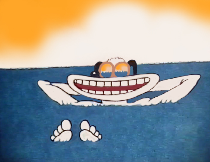 Still from Chocolate Bubbis, the surfer floats face up in the sea with a huge grin and his feet in front