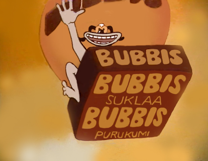 Still from Chocolate Bubbis, the character waves and holds up a brown pack lettered BUBBIS SUKLAA BUBBIS PURUKUMI