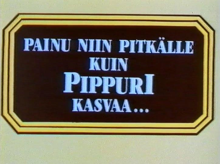 A dark ornate plaque with cream lettering set on a plain pale card.