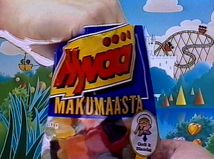A bag of Malaco sweets held to camera, Hyvää Makumaasta on the label.