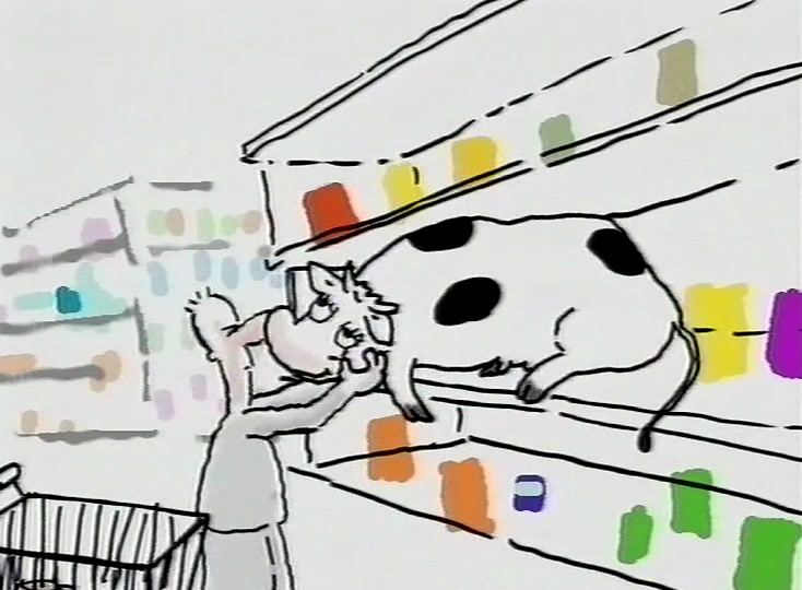 A black and white cow stands on the shelf while the shopper reaches up towards it