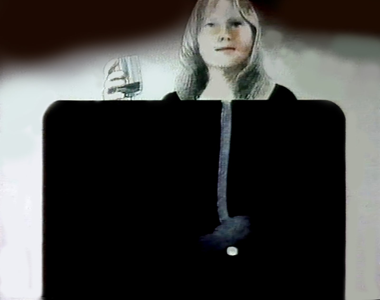 Still from Treo, a woman holds a glass above a black diagram showing her throat, stomach and a white tablet