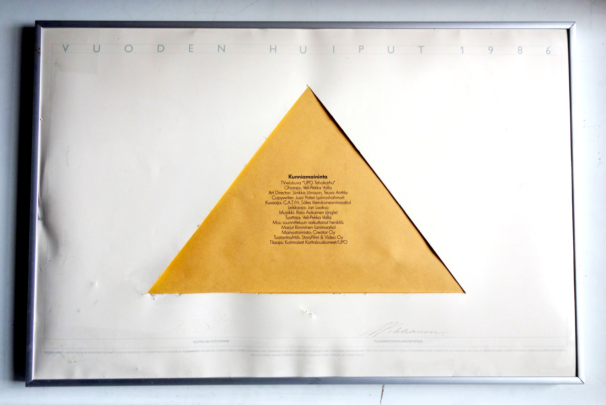 Framed white placard headed VUODEN HUIPUT 1986, with a yellow triangle carrying the honourable mention for the TV film UPO Tehokarhu and naming Marjut Rimminen for animation