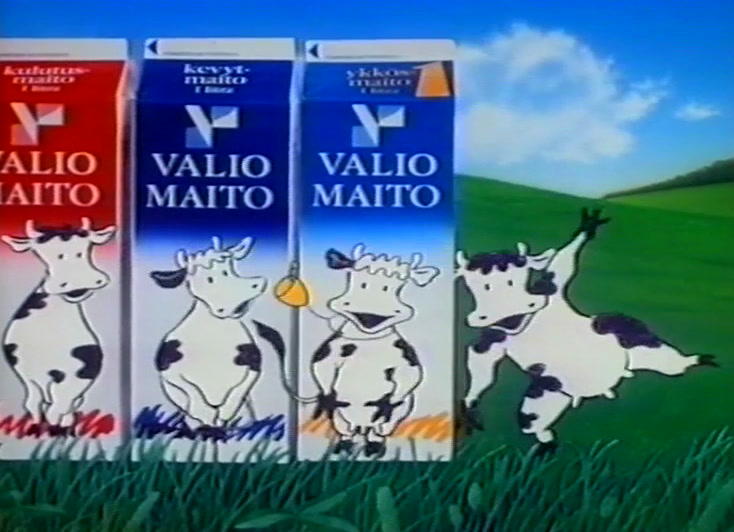 Three cartons in a row, cows lined up beside them, a fourth leaping in the field.