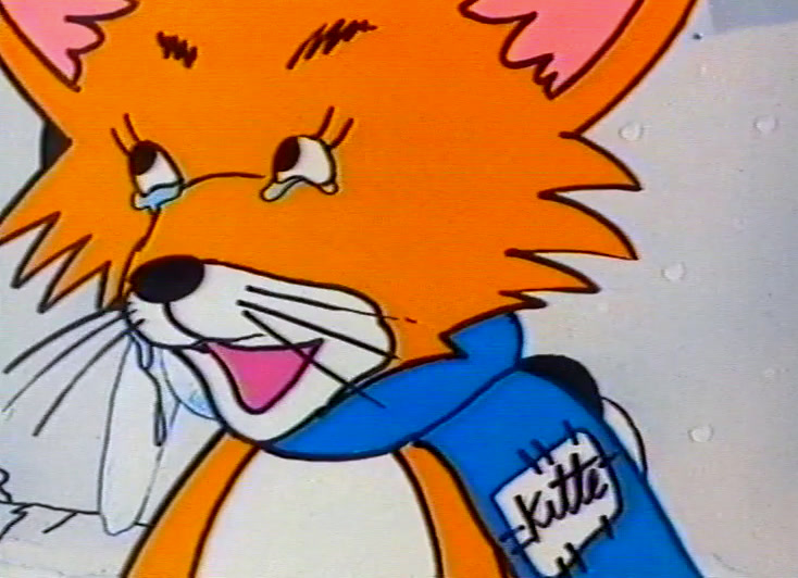 The orange fox laughs open-mouthed, blue scarf at its neck, snow behind.