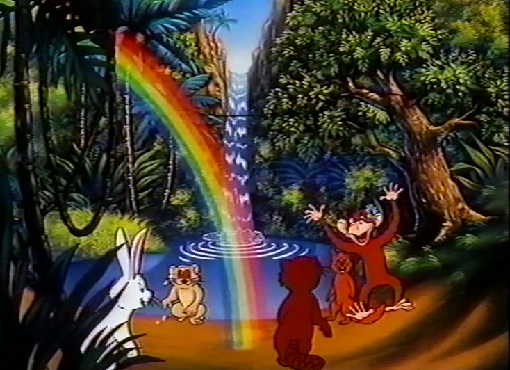 Rainbow and waterfall in a dark jungle with small animals gathered at lower right.