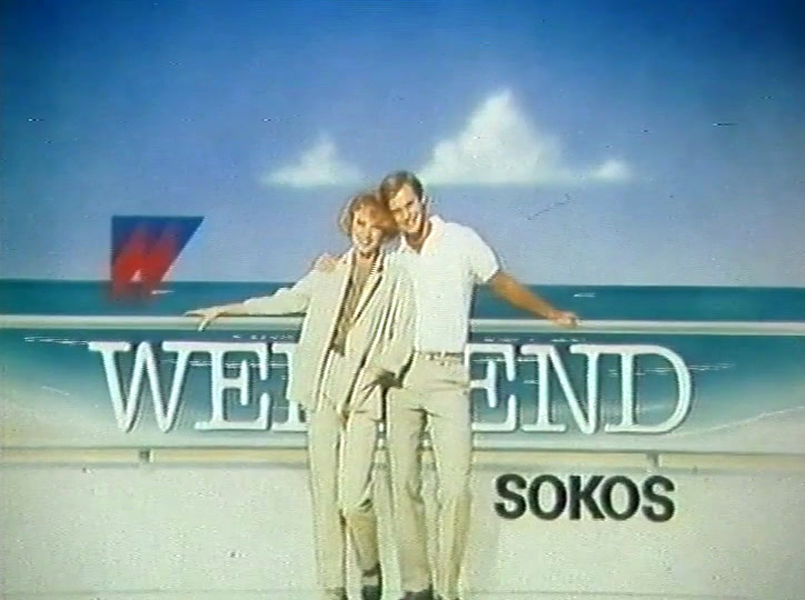 A couple in cream lean on the white rail; SOKOS sits bottom right.