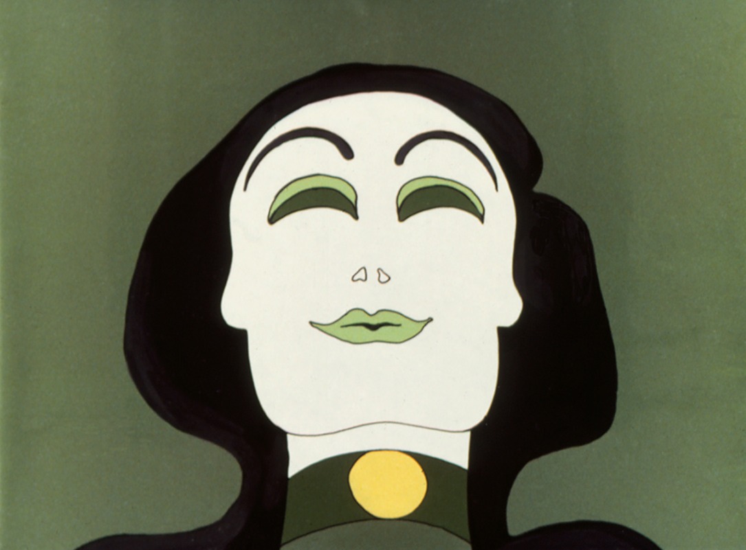 Still from Yaxa Cabaret: a white face with closed green eyelids and green lips, framed in black hair, on a sage green ground.