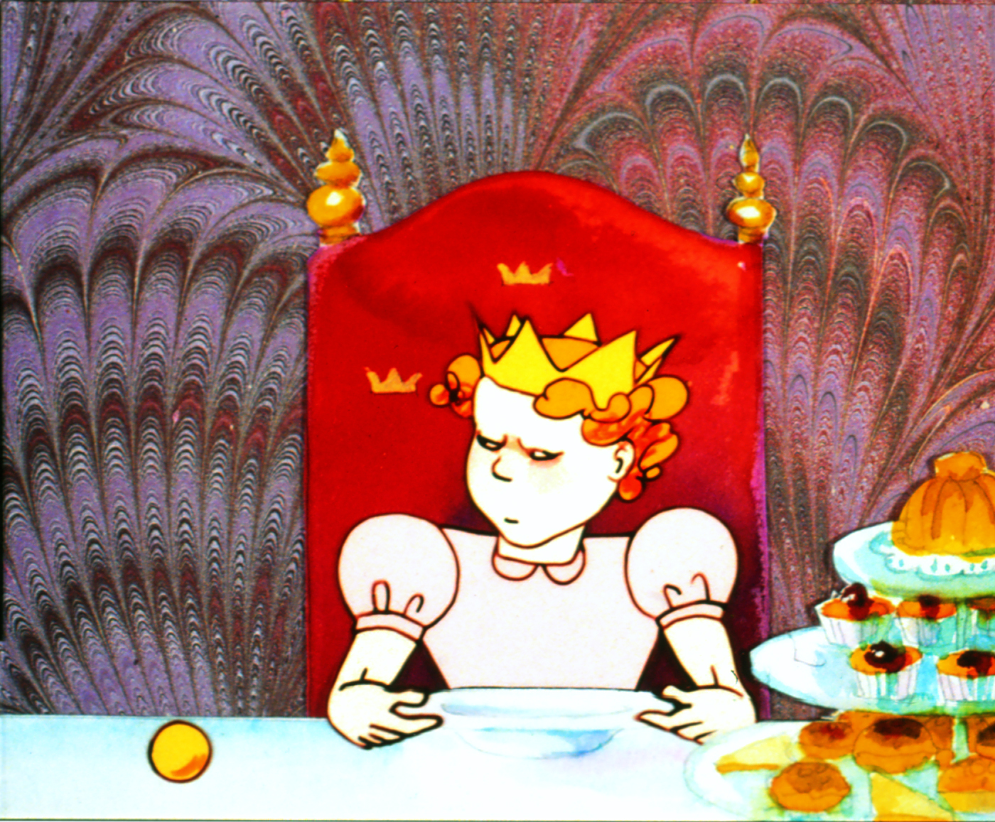 Still from The Frog King, the princess sits before a plate, a golden ball and small cakes