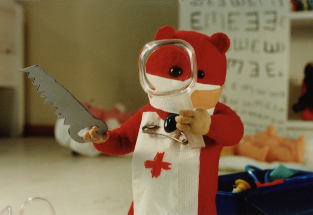 Still from Urpo and Turpo — Turpo in a surgeon's mask wielding a toy saw