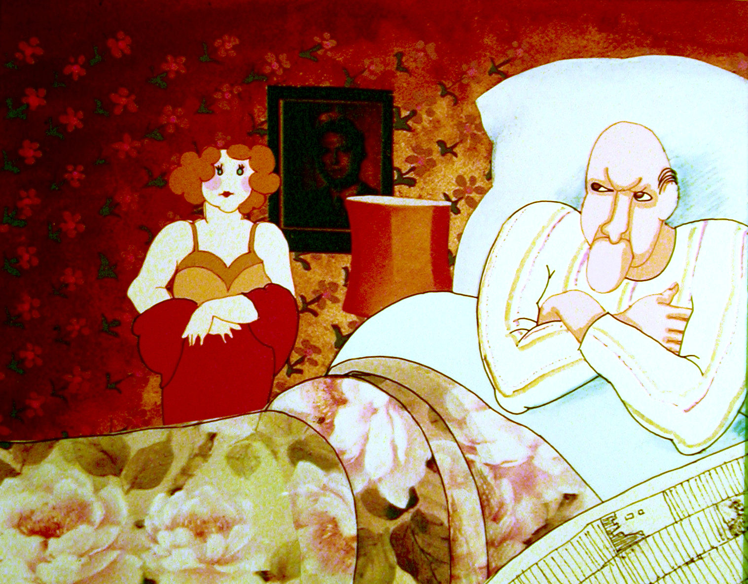 Valintatalo still, the woman with orange curls sits at the foot of the bed against red floral wallpaper, a framed portrait behind her, while the bald, moustached man sits up under the covers with his arms folded and does not look at her